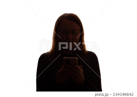 Silhouette of young woman using smartphone on white background Silhouette of young woman using smartphone on white background 134196642