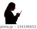 Silhouette of young woman using smartphone on white background 134196652