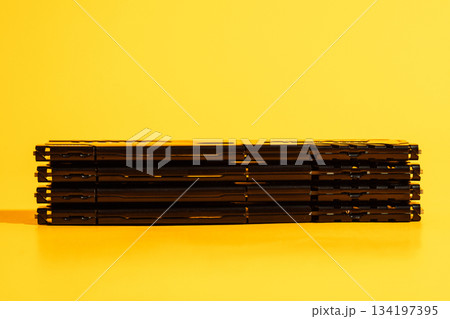 Long horizontal stack of black RAM modules on yellow background 134197395