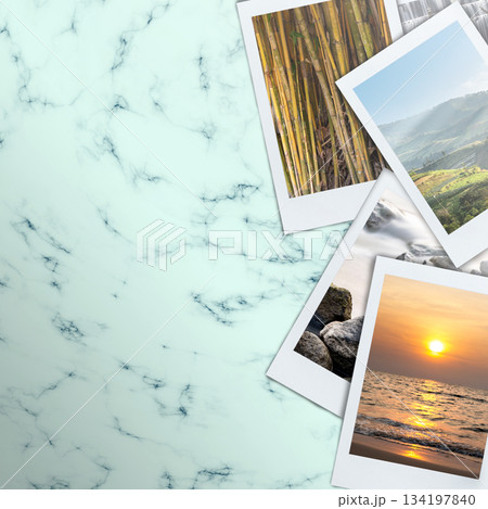 Minimalist aesthetic background featuring a light marble texture with instant style pictures showcasing different nature scenes. Great for social media post, product display or digital mockup 134197840