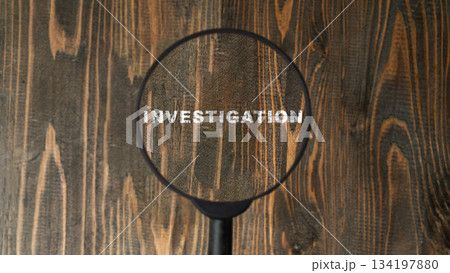 Magnifying glass highlights the word INVESTIGATION on a textured wooden surface. Concept of Investigation Magnifying glass highlights the word INVESTIGATION on a textured wooden surface. Concept of Investigation 134197880
