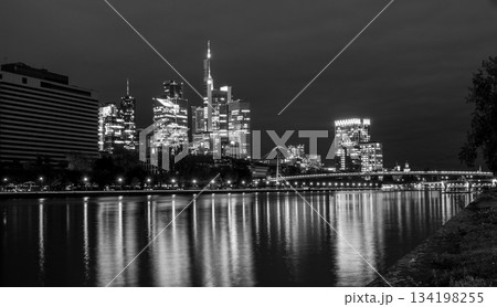 Frankfurt skyline in the evening. Sunset at blue hour with illuminated skyscrapers from the financial and business district 134198255