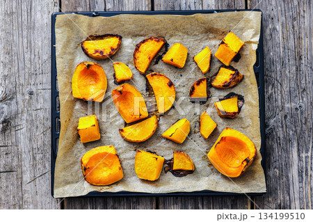 baked butternut squash slices on a sheet pan 134199510