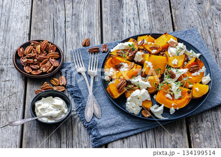 baked butternut squash with cheese, thyme, pecan 134199514
