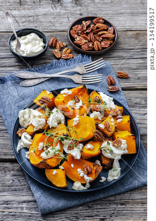 baked butternut squash with cheese, thyme, pecan baked butternut squash with cheese, thyme, pecan 134199517