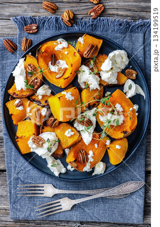baked butternut squash with cheese, thyme, pecan 134199519