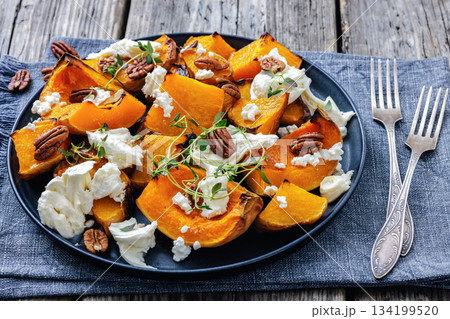 baked butternut squash with cheese, thyme, pecan 134199520