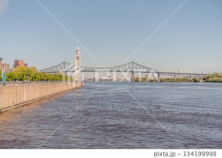 Ferris wheel built at the Old Port of Montreal in Canada in sunny weather 134199998