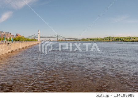 Ferris wheel built at the Old Port of Montreal in Canada in sunny weather 134199999