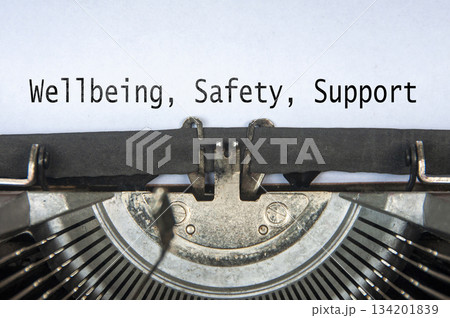 Wellbeing, Safety and Support text on old typewriter. 134201839