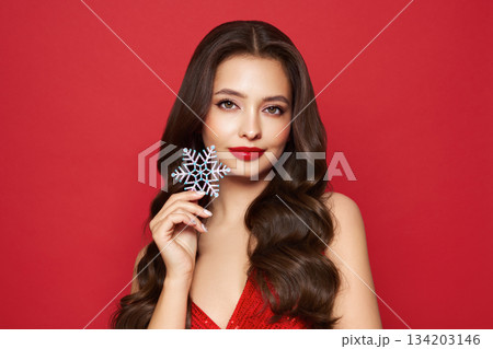 Beautiful young woman with glowing snowflake Beautiful young woman with glowing snowflake 134203146