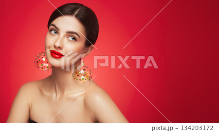 Portrait of beautiful young woman on red background 134203172