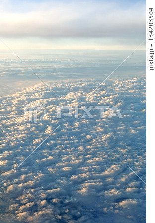 Vast expanse of fluffy white clouds seen from above during a flight Vast expanse of fluffy white clouds seen from above during a flight 134203504