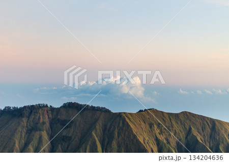 Green mountain ridge under soft twilight sky in Lombok. Green mountain ridge under soft twilight sky in Lombok. 134204636