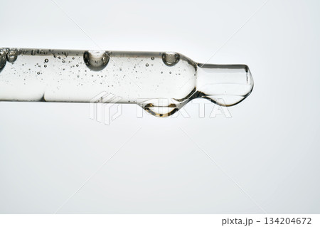 Cosmetic pipette dropping transparent serum for skincare routine 134204672
