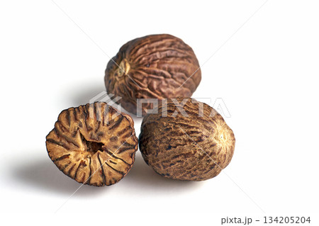 three dried aromatic nutmegs isolated on white background. three dried aromatic nutmegs isolated on white background. 134205204
