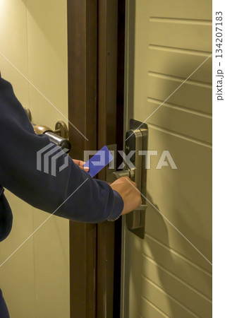 Latin young men opens a door with a keycard in a hallway, key electronic lock, hotel room, holidays in mallorca, spain 134207183
