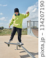 young, teenager, with skateboard, jumping, on the track, with headphones, 134207190