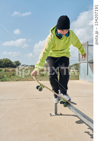 young, teenager, with a skateboard, jumping, on a track, skateboarding, wearing headphones young, teenager, with a skateboard, jumping, on a track, skateboarding, wearing headphones 134207191
