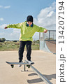 young, teenager, with skateboard, jumping, on the track, with headphones, 134207194