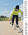 young, teenager, with a skateboard, jumping, on a track, skateboarding, wearing headphones 134207195