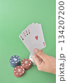 hand playing cards on green table 134207200