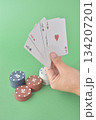 hand playing cards on green table 134207201