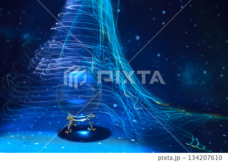Ethereal Light Swirl. A crystal ball surrounded by swirling blue and white light trails 134207610