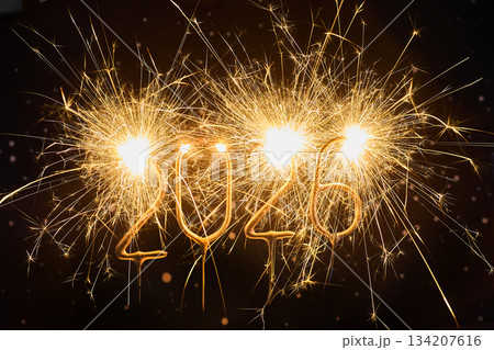 Sparkling New Year 2026. Dazzling sparklers form the number 2026 against a dark backdrop 134207616