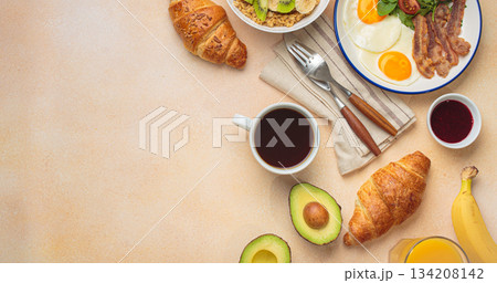 Breakfast warm beige background eggs vegetables salad, oats fruit, croissants, coffee, juice healthy morning. 134208142