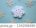 White snowflakes on a blue background. 134208480