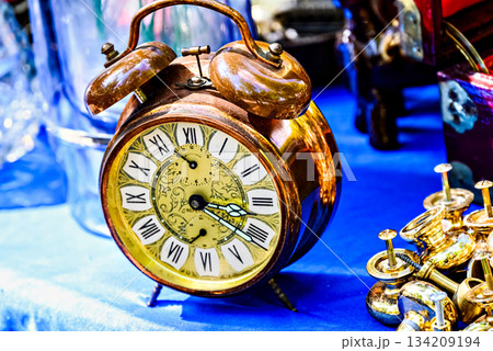 Antique gold alarm clock on display. Vintage, retro Antique gold alarm clock on display. Vintage, retro 134209194