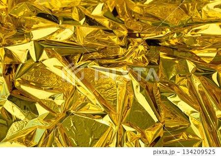 high-resolution close-up shot of crumpled golden foil 134209525