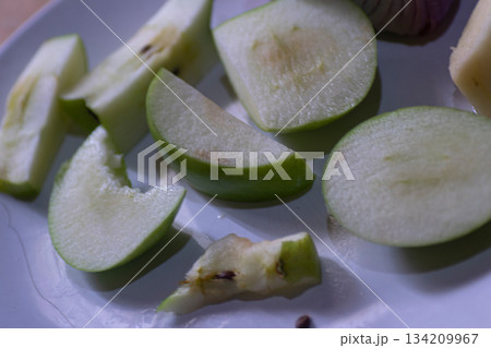 Apples slices and red onion on a white plate 134209967