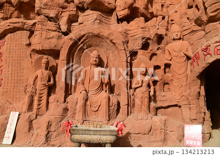 Buddha statue sculpture on the cliff face of the temple in front of the entrance gate at the Tianshan Grand Canyon, or Kesileya Grand Canyon, is a stunning natural feature in Xinjiang, China,  134213213