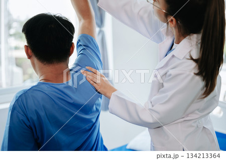 Female Doctor and patient suffering from back pain during medical exam. Female Doctor and patient suffering from back pain during medical exam. 134213364