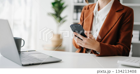 Businesswoman s hands typing on smartphone, tablet and laptop computer 134213408