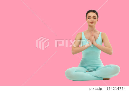 Yoga session with person meditating in simple studio 134214754
