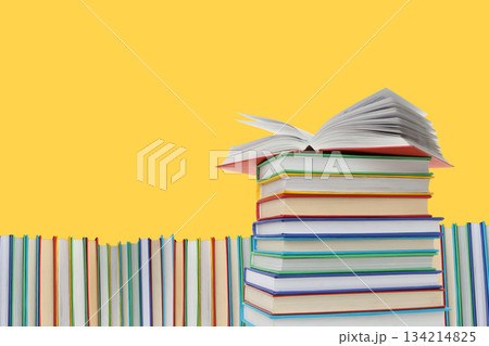 Stacked books with one open on top create blank space 134214825