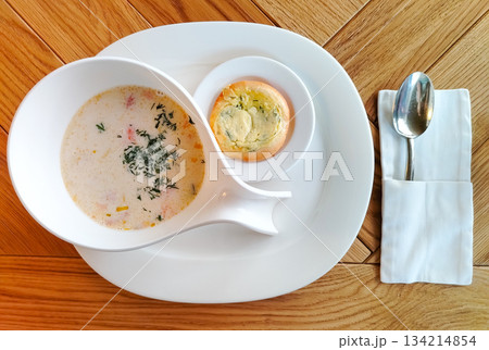Norwegian fish soup creamy salmon chowder in white bowl on wooden table horizontal Norwegian fish soup creamy salmon chowder in white bowl on wooden table horizontal 134214854