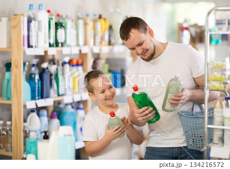 Schoolboy son and dad are choosing dishwashing in store Schoolboy son and dad are choosing dishwashing in store 134216572