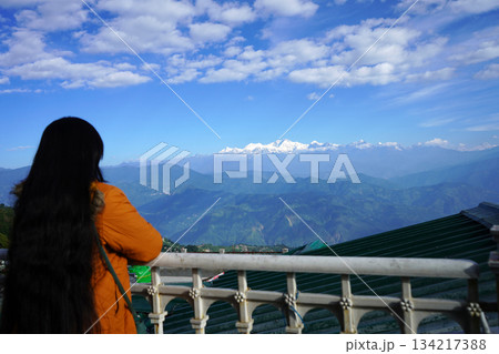 Rear view of woman overlooking snow-capped Kanchenjunga 134217388