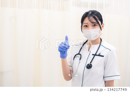 マスクと手袋をつけて働く女性の医療従事者 134217749