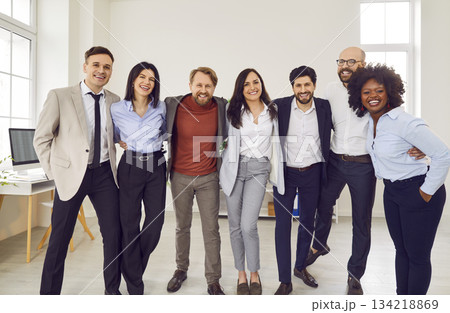 Group portrait of a happy smiling diverse business people at work in office. Group portrait of a happy smiling diverse business people at work in office. 134218869