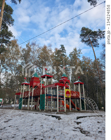 Colorful Playground in Snowy Park Under Blue Sky Colorful Playground in Snowy Park Under Blue Sky 134224858