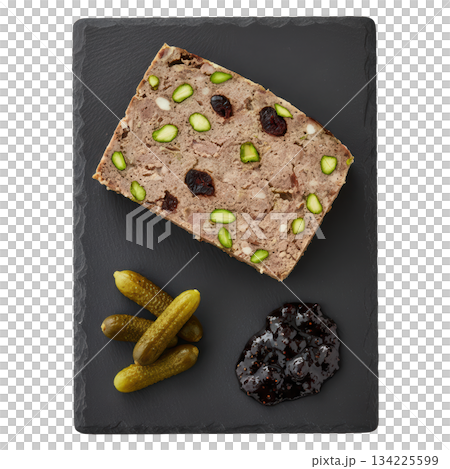 Savory country pate with pistachio, fig jam, and cornichon. delicious French appetizer on dark slate platter 134225599