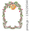 Christmas wreath of yellow glass bauble and yew branches in the arch shape. Hand painted watercolor. Pink and green create a dreamlike winter look. Perfect for festive frame template and card design. 134226544