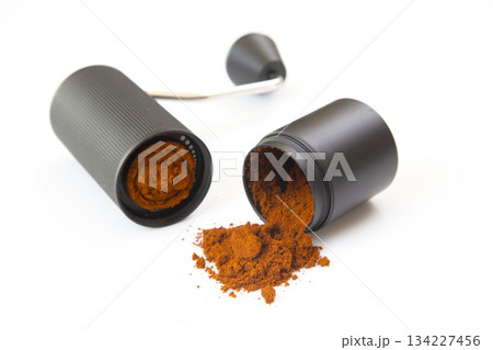 A modern manual coffee grinder, opened to show ground coffee A modern manual coffee grinder, opened to show ground coffee 134227456