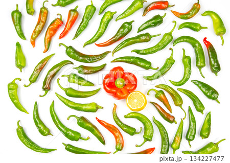green hot peppers and red and yellow bell peppers on a white background green hot peppers and red and yellow bell peppers on a white background 134227477