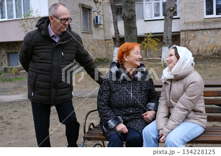 Grandfather and granddaughter went to a restaurant, meeting grandfather, grandmother and a teenage girl, walking together, socializing Grandfather and granddaughter went to a restaurant, meeting grandfather, grandmother and a teenage girl, walking together, socializing 134228125